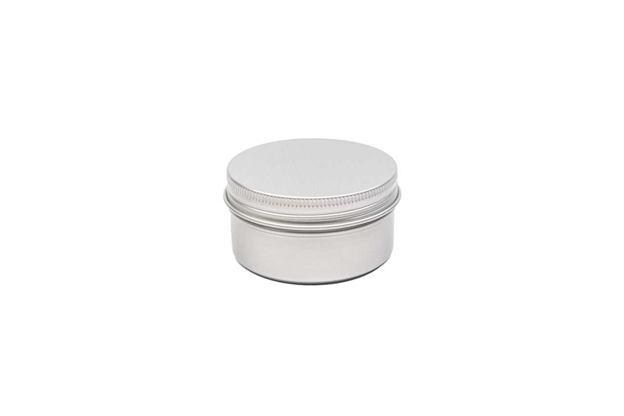 Boîte à savon ronde fermée en métal couleur argent avec couvercle à vis, fond neutre.